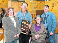 Angela and Gary Lock, Linda-Vista, Kongal receive the perpetual trophy for the winning two fleeces from Mundulla Hogget Competition founder Ed Champness, and Tony Biddle, representing sponsor Tatiara Insurance Agencies.